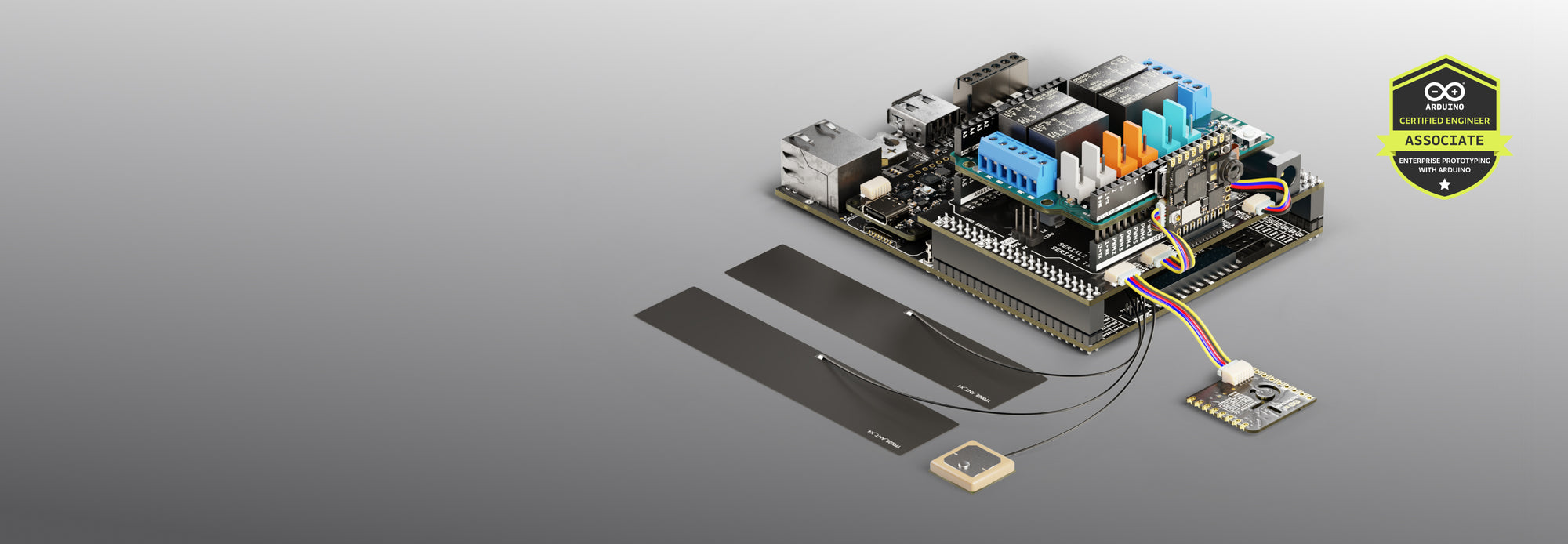 Arduino development board connected to multiple sensors and modules, including a GPS module and strip sensors, on a gray background with a Certified Engineer Associate badge.